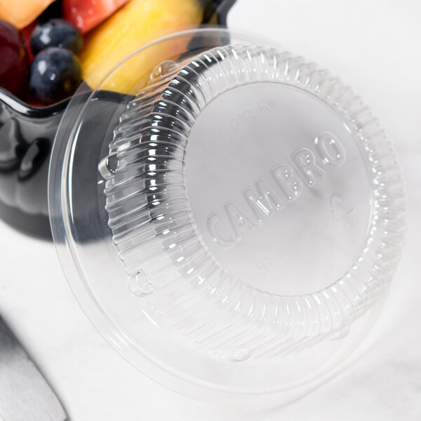 A clear plastic container with a lid and fruit in it.