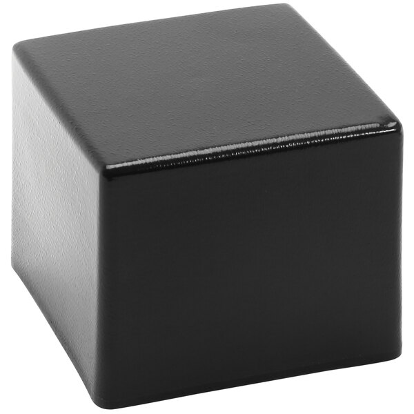A black Delfin CR-665 Elevations pedestal cube on a white surface.