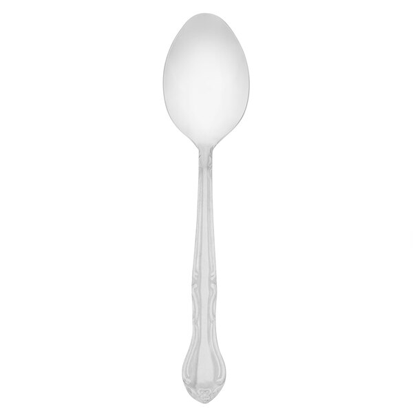 A Walco stainless steel dessert spoon with a white handle.