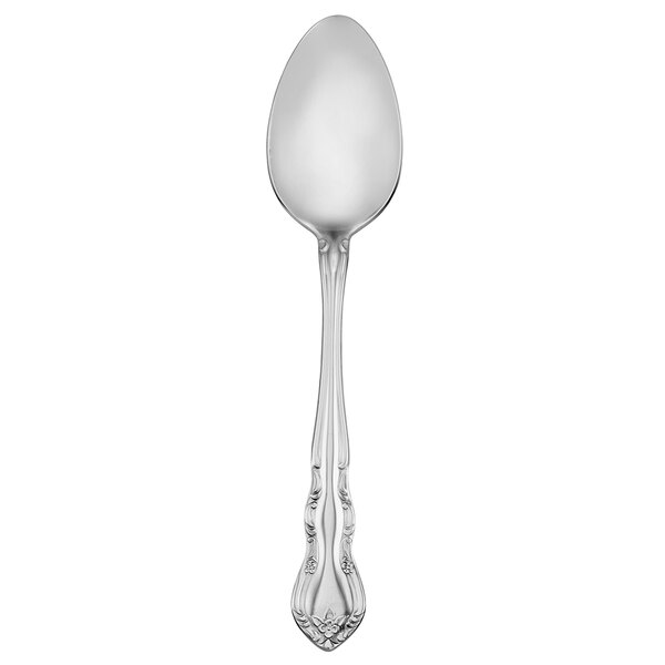 A silver Walco Discretion dessert spoon with a handle.