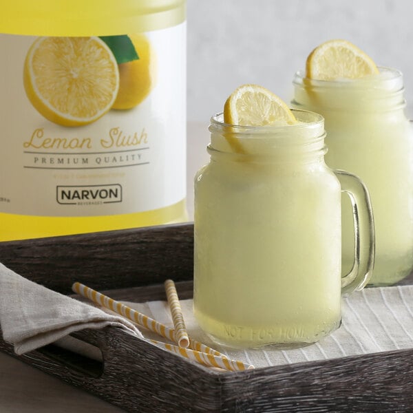 A glass jar of Narvon Lemon Slushy concentrate with a straw in it.