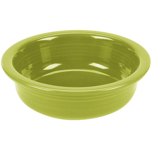 A green Fiesta serving bowl on a white surface.