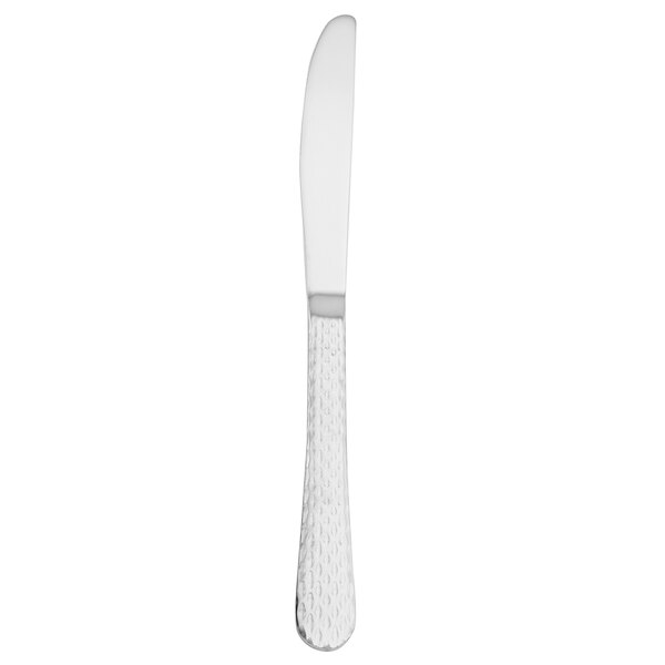 A silver Walco stainless steel dinner knife with a white handle.