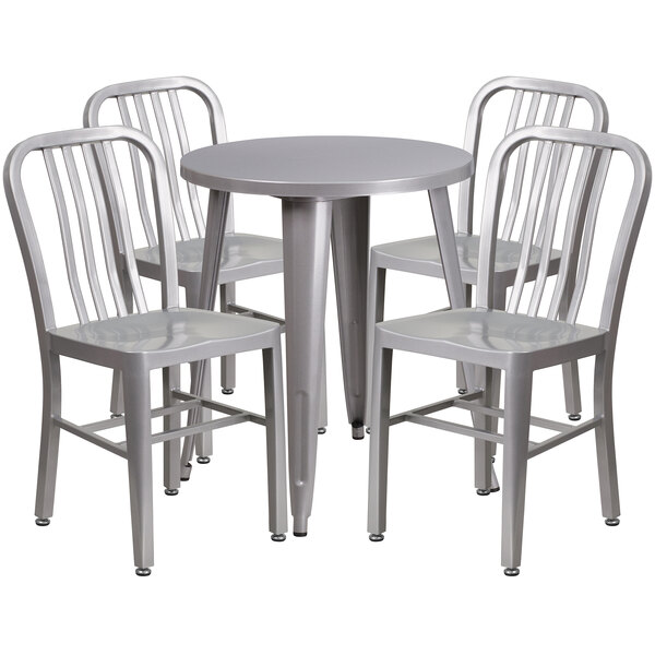 A close-up of a Flash Furniture silver metal table and four vertical slat back chairs.