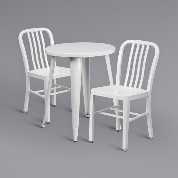 A white Flash Furniture table with 2 white chairs.