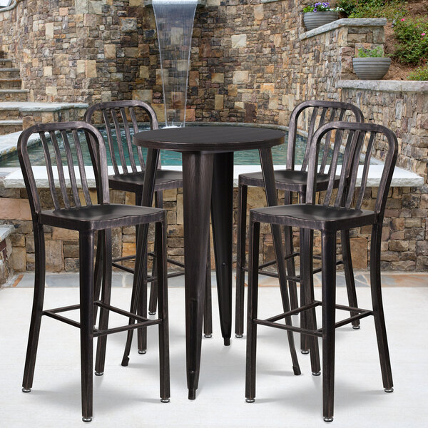 A Flash Furniture black metal bar table with four black chairs on an outdoor patio.