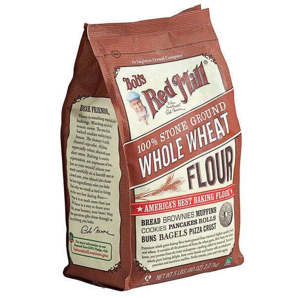 A white bag of Bob's Red Mill Whole Wheat Flour with a white label.