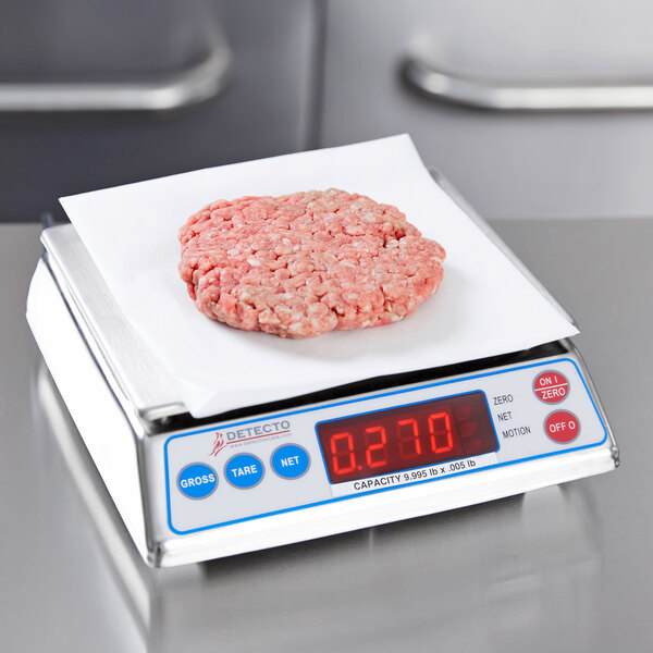 A Cardinal Detecto digital portion scale with meat on it.