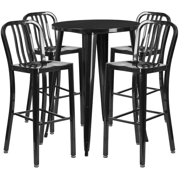 A black metal bar table with four black vertical slat back stools around it.