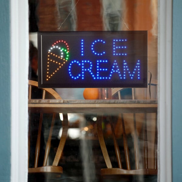 A white rectangular LED sign that says "Ice Cream" with blue lights.