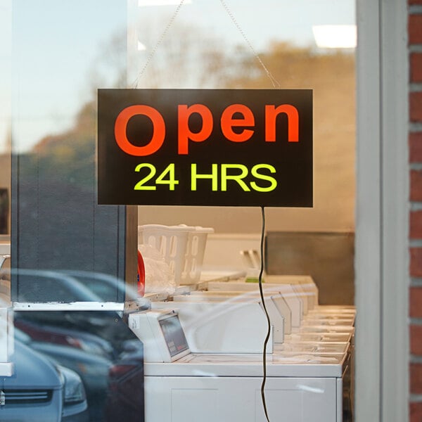 A white rectangular LED sign that says "Open 24 Hours" with two display modes.