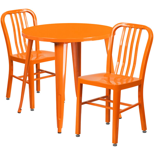 An orange metal Flash Furniture table with two chairs.