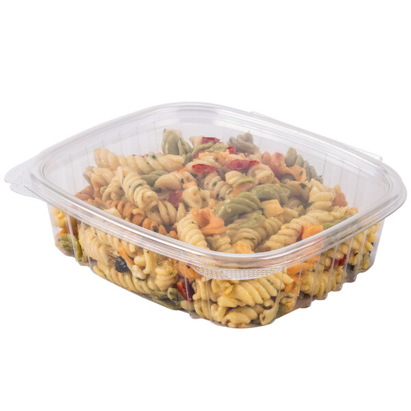 A clear Genpak plastic deli container filled with pasta and other ingredients.