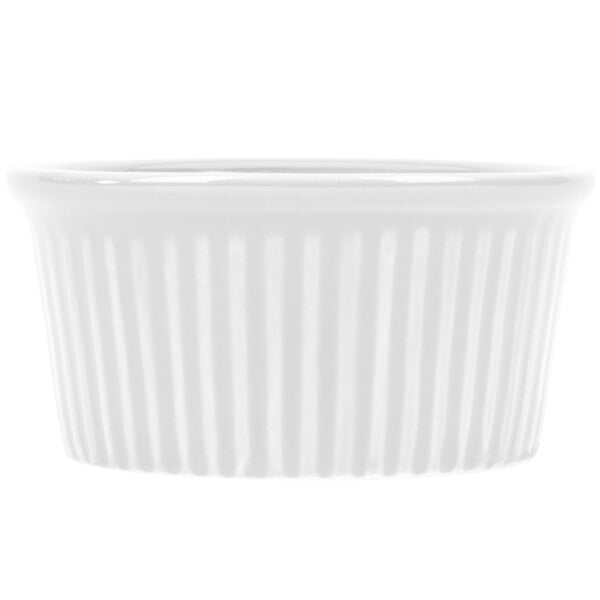 A close-up of a CAC RKF-4 Festiware white ramekin with a ribbed pattern.