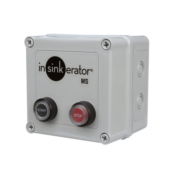 A white InSinkErator switch with buttons and a black circle on it.