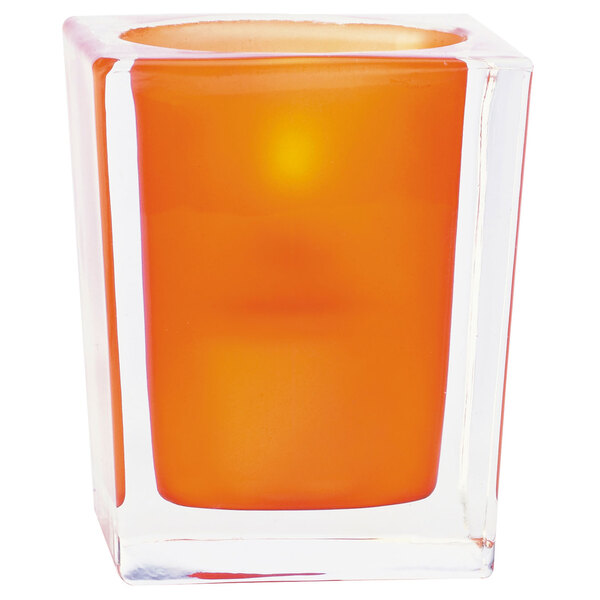 A square clear cube with an orange Sterno candle inside.