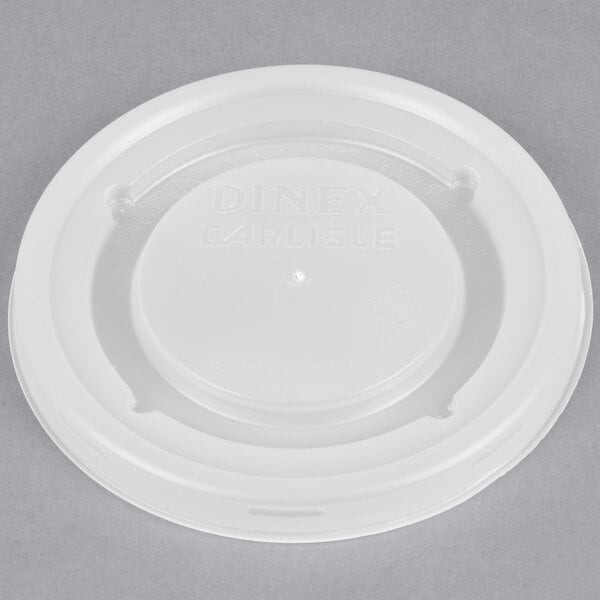 A close-up of a white plastic Dinex lid with a logo on it.