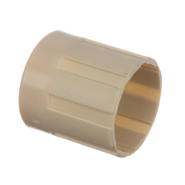 A close-up of a circular beige plastic pipe fitting.