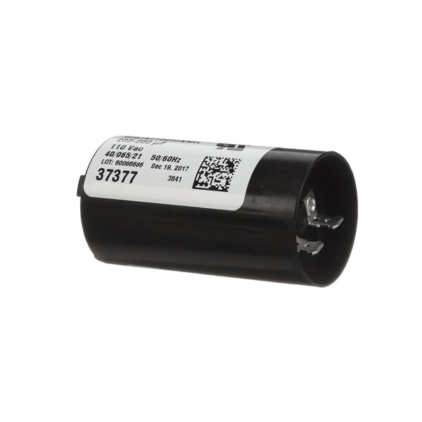 A black cylindrical Speed Queen start capacitor with a white label.
