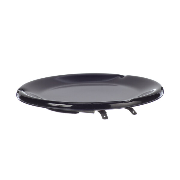 A black round warming plate with metal clips.