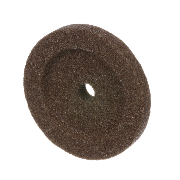 A brown circular Hobart truing wheel with a hole in the middle.