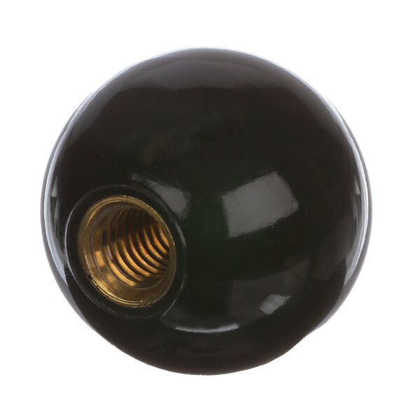 A black round knob with a gold screw on it.