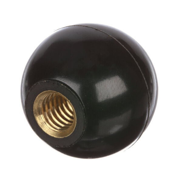 A black round knob with a gold nut on it.