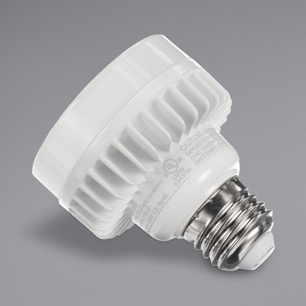 A close-up of a Component Hardware white light bulb with a silver base.