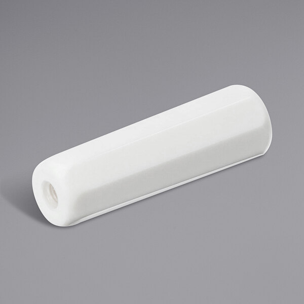 A white rectangular plastic handle with a cylindrical white surface and a small hole in it.