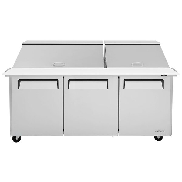 A stainless steel Turbo Air refrigerated sandwich prep table with three doors.