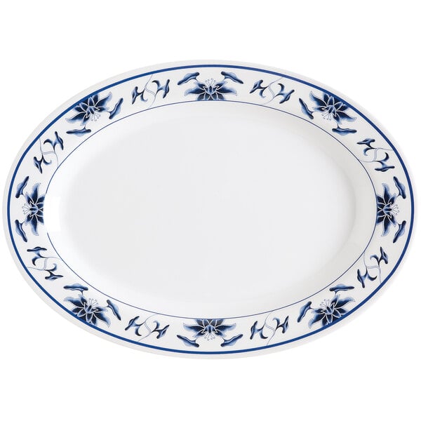 A white oval melamine platter with blue flowers on it.