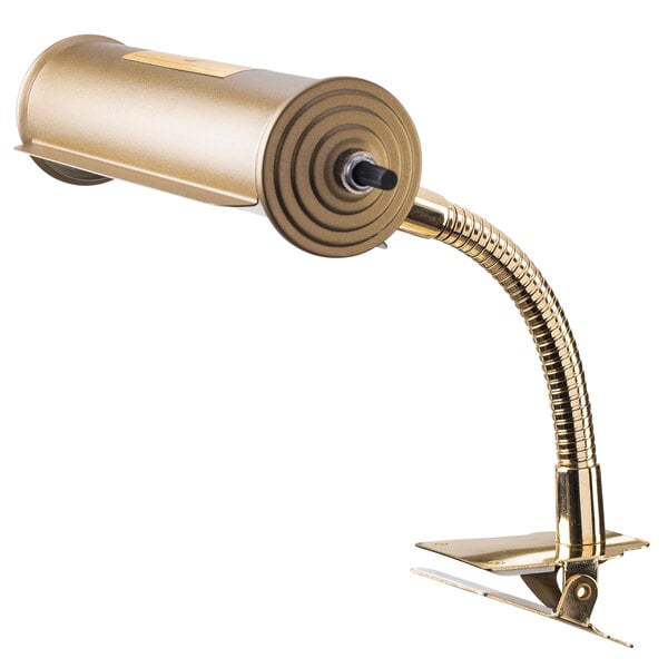 An Oklahoma Sound brass reading lamp clipped to a desk.