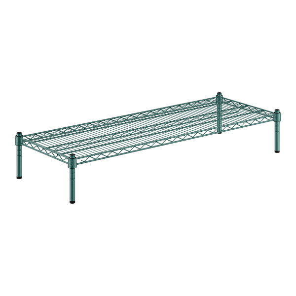 A close-up of a green metal shelf with black legs.