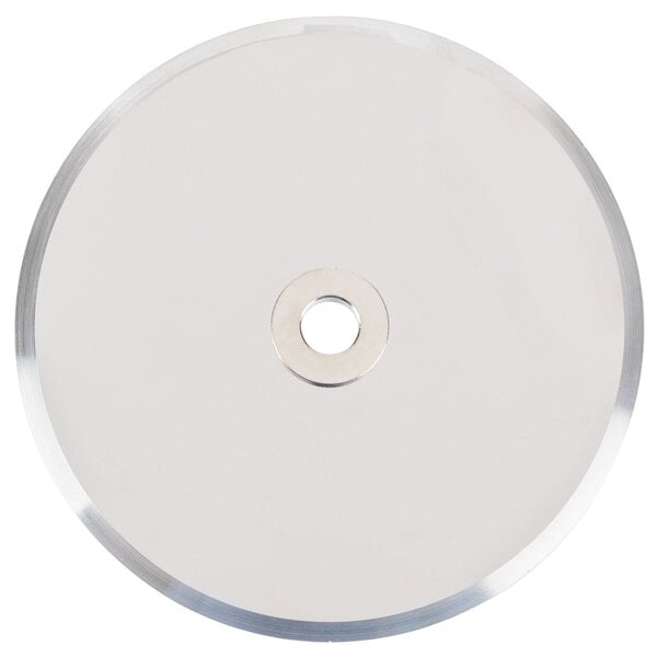 A circular silver metal disc with a hole in the middle.