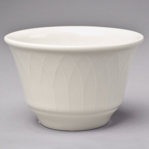 A close-up of a Homer Laughlin ivory china bowl with a pattern on it.