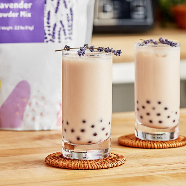 Two glasses of bubble tea with lavender sprigs on top.