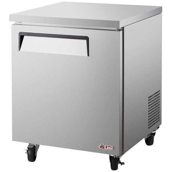 A Turbo Air stainless steel undercounter freezer with a black handle on wheels.