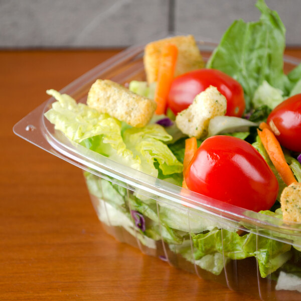 A salad in a Dart clear rectangular plastic container.