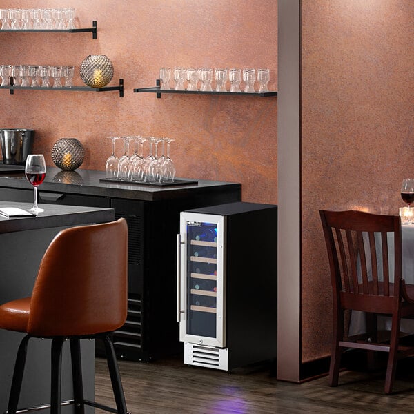 An AvaValley commercial wine cooler in a room with a table set with wine glasses.