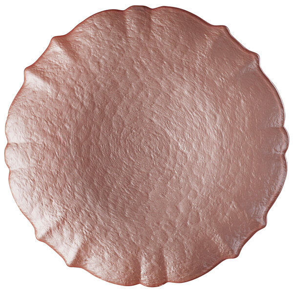 A Charge It by Jay pink glass charger plate with a scalloped edge.