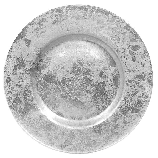 A close-up of a silver leaf glass charger plate with a rough surface.