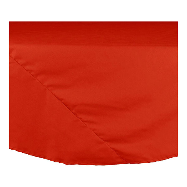 A red round Intedge table cloth on a table.