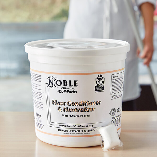 A white tub of Noble Chemical QuikPacks floor conditioner and neutralizer with 90 packs inside.