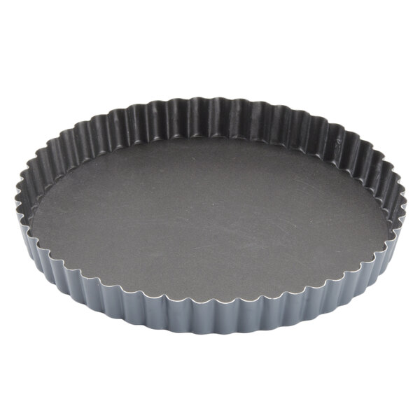 A black round pan with a wavy edge.