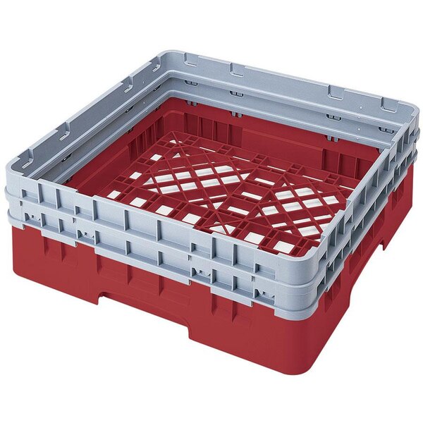 A red plastic Cambro dish rack with red plastic inserts.