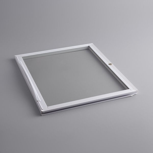 A white square glass lid with a white handle.