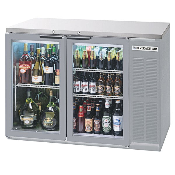 A Beverage-Air stainless steel back bar refrigerator with a glass door filled with bottles of beer.