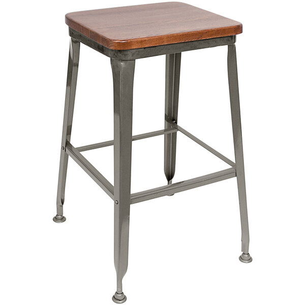 A BFM Seating Lincoln clear coated steel backless bar stool with an ash wood seat.