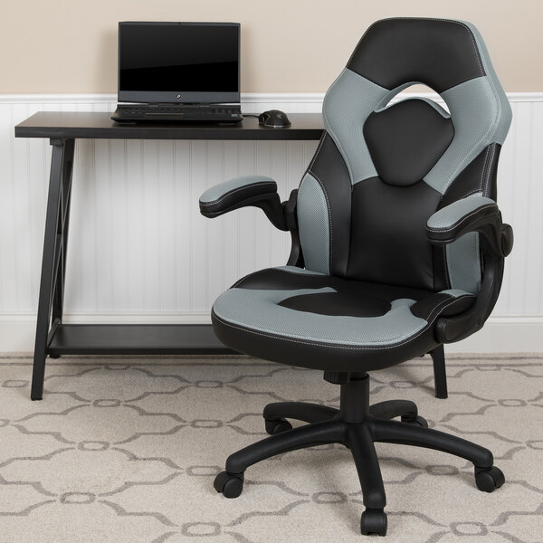 A black and gray Flash Furniture office chair with a laptop on a desk.