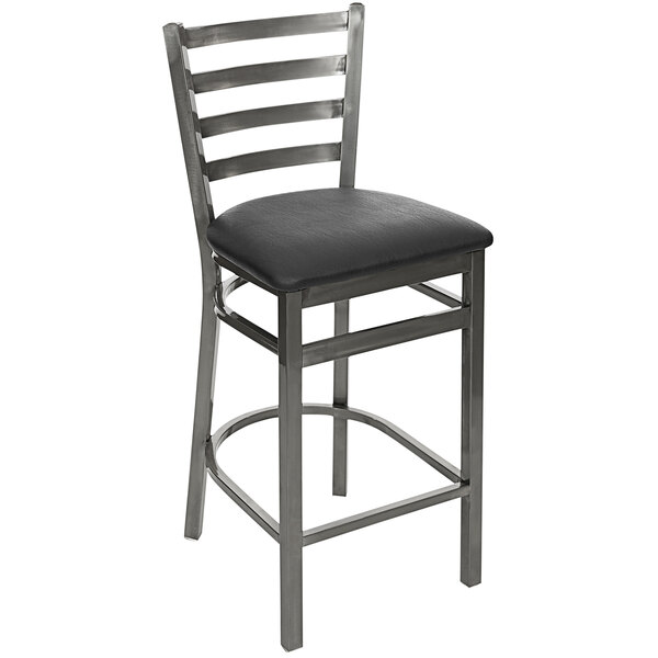 A BFM Seating clear coated steel bar stool with a black vinyl seat.